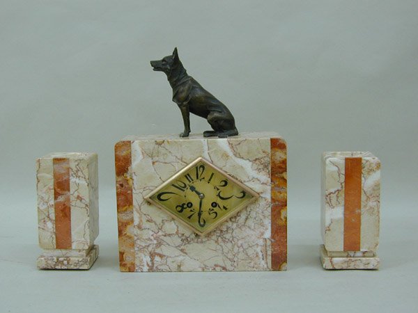 Art deco marble garniture clock set: Art deco marble garniture clock set, mounted with a patinated metal seated dog, 14.5''h