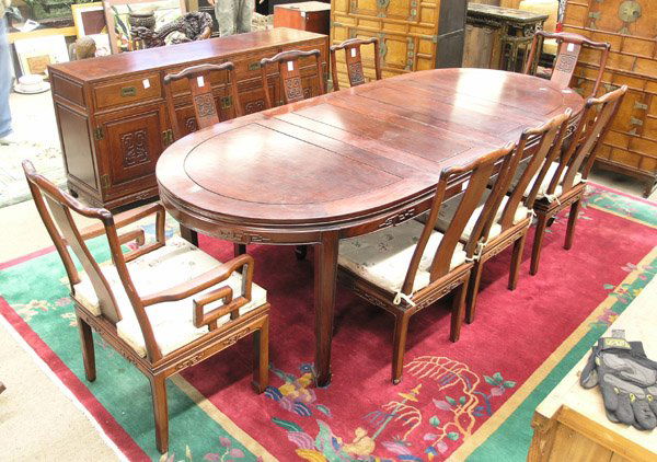 Chinese Hardwood Dining Room Set: Chinese hardwood dining table with eight chairs and buffet cabinet, the round table with two extension leaves and with a plain apron with occasional raised keyfret bead and resting on straight support