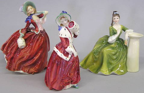 Three Royal Doulton Figurines of Beauties: Three Royal Doulton figurines of Beauties: ''Christmas Morn,'' ''Secret Thoughts''' ''Autumn Breezes.'' (Autumn Breezes has a hairline crack to bottom, other two are in very good condition.) Tallest