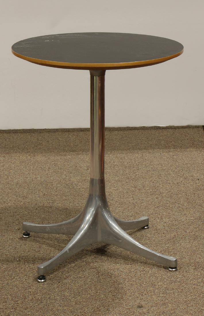 George Nelson occasional table: George Nelson occasional table, having a circular black top, above aluminum and chrome legs, 21"h x 17"dia.