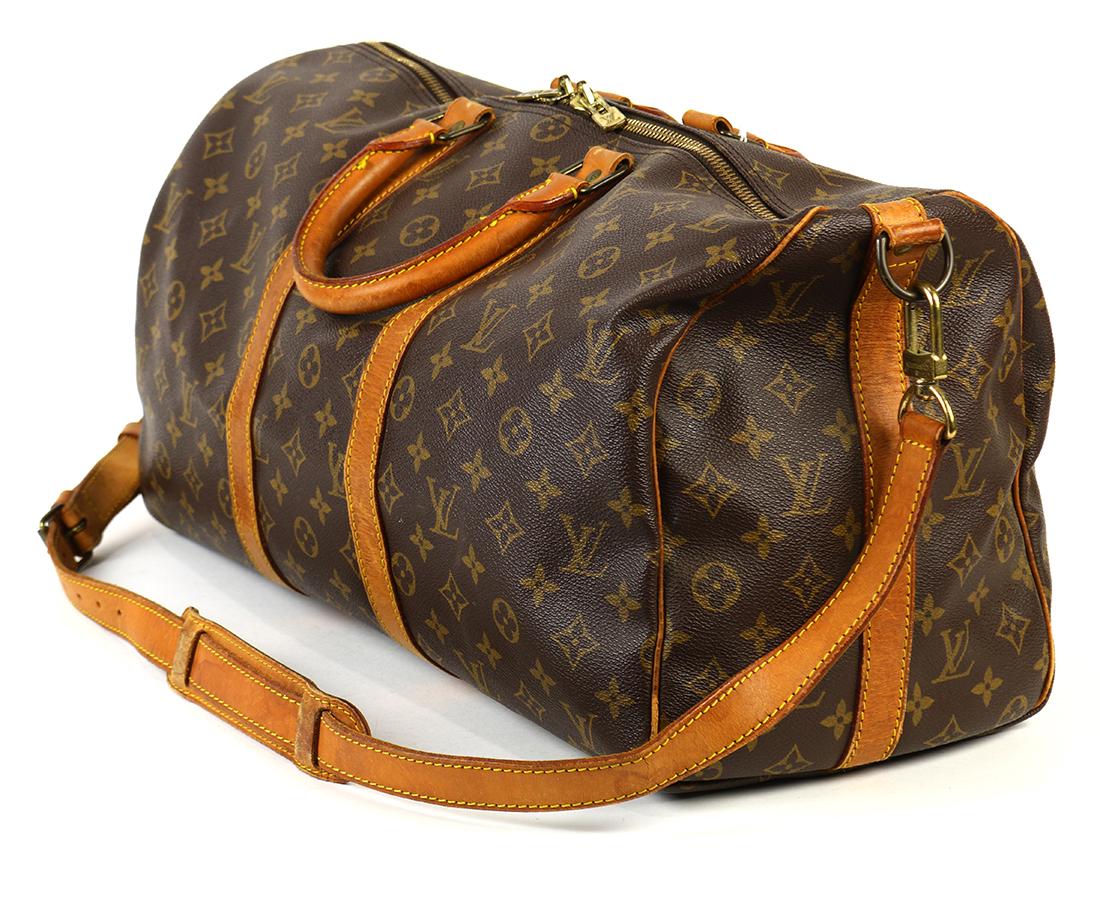 Louis Vuitton Keepall Bandouliere travel bag: Louis Vuitton Keepall Bandouliere travel bag, 45cm, executed in brown monogram coated canvas, 12"h x 18"w x 8.5"d. (Note: Please see additional luxury lots in our Saturday catalog.)
