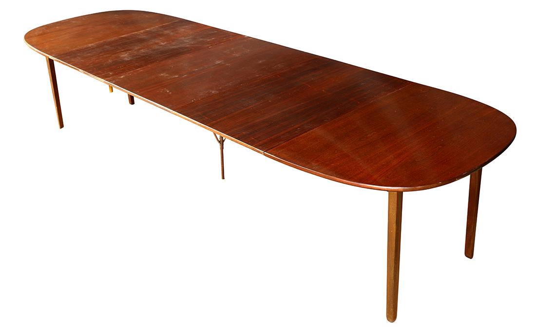 Danish Modern Ole Wanscher for PJ Mobler produced by P.: Danish Modern Ole Wanscher for PJ Mobler produced by P. Jeppesen mahogany dining table circa 1960, the circular top having (3) 25.5"l leaves, and rising on square legs, closed: 29"h x 57.5"w x 40.5"d
