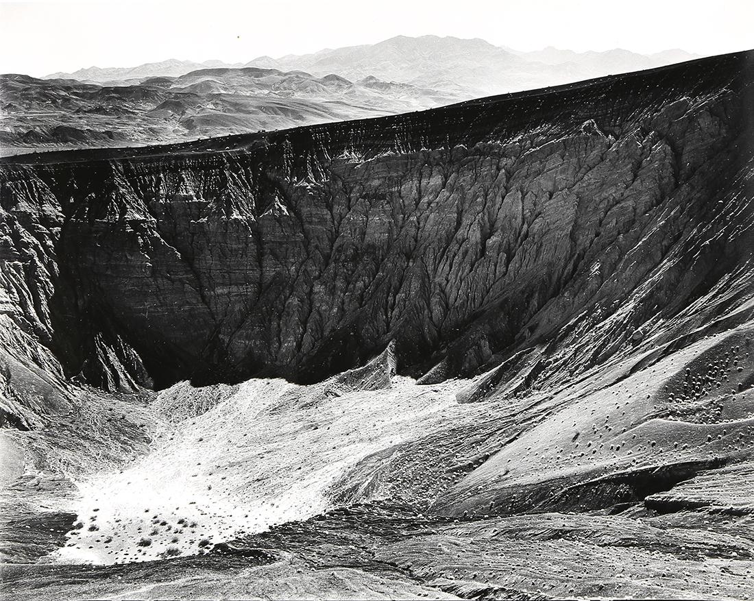 Photograph, Ansel Adams, Ubehebe Crater, Death Valley: Ansel Adams (American, 1902-1984), "Ubehebe Crater, Death Valley National Monument," circa 1949, gelatin silver print, titled in pen verso, artist stamp "Photograph by Ansel Adams 131 - 24th Avenue, S