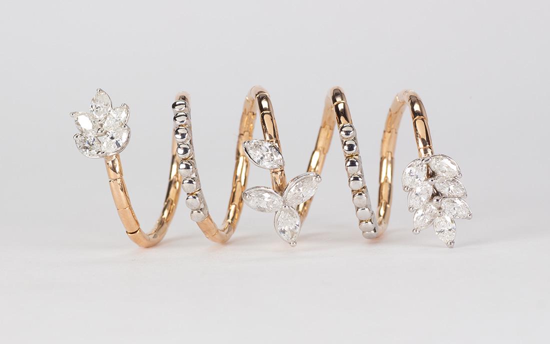 Diamond and 18k yellow gold ring: Diamond and 18k yellow gold ring Featuring (16) marquise-cut diamonds, weighing a total of approximately 1.90 cts., set in an 18k yellow gold, coil form mounting, measuring approximately 47 mm, size 5