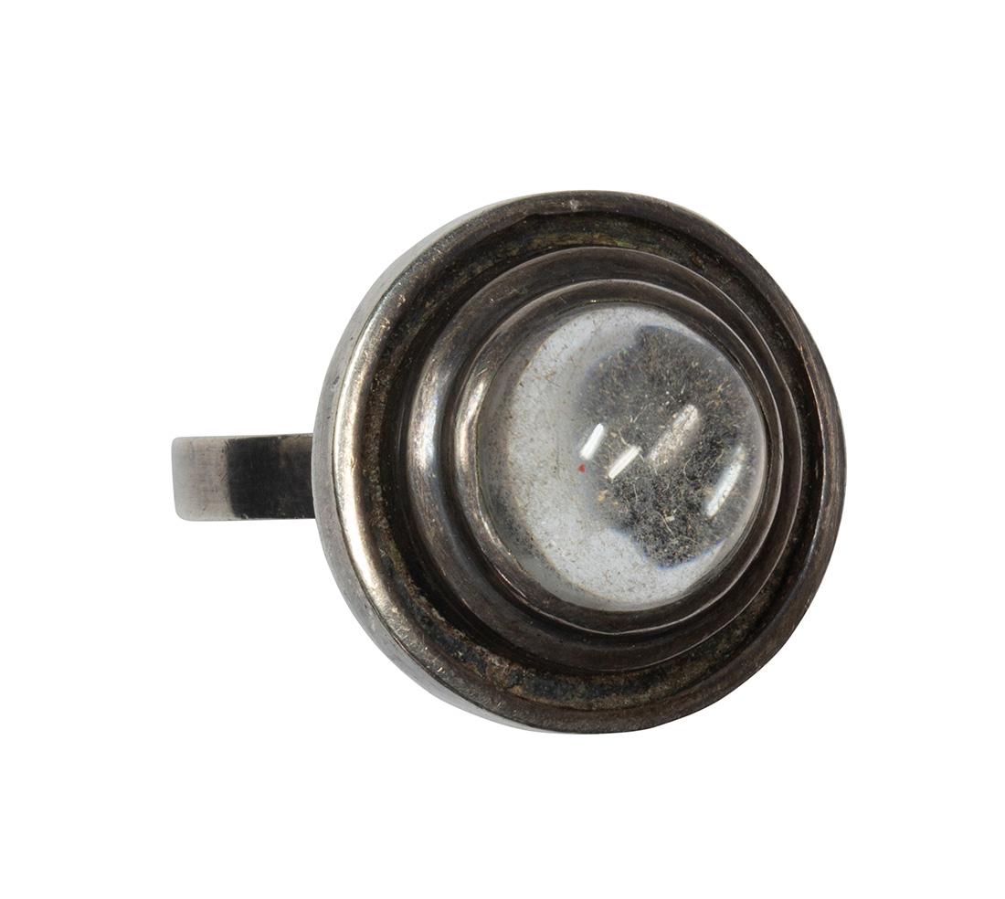 Peter Macchiarini rock crystal quartz and sterling: Peter Macchiarini rock crystal quartz and sterling silver ring Centering (1) round rock crystal quartz cabochon, measuring approximately 11.1 mm, set in a silver ring, (marked MACCHIARINI), size 7.25,