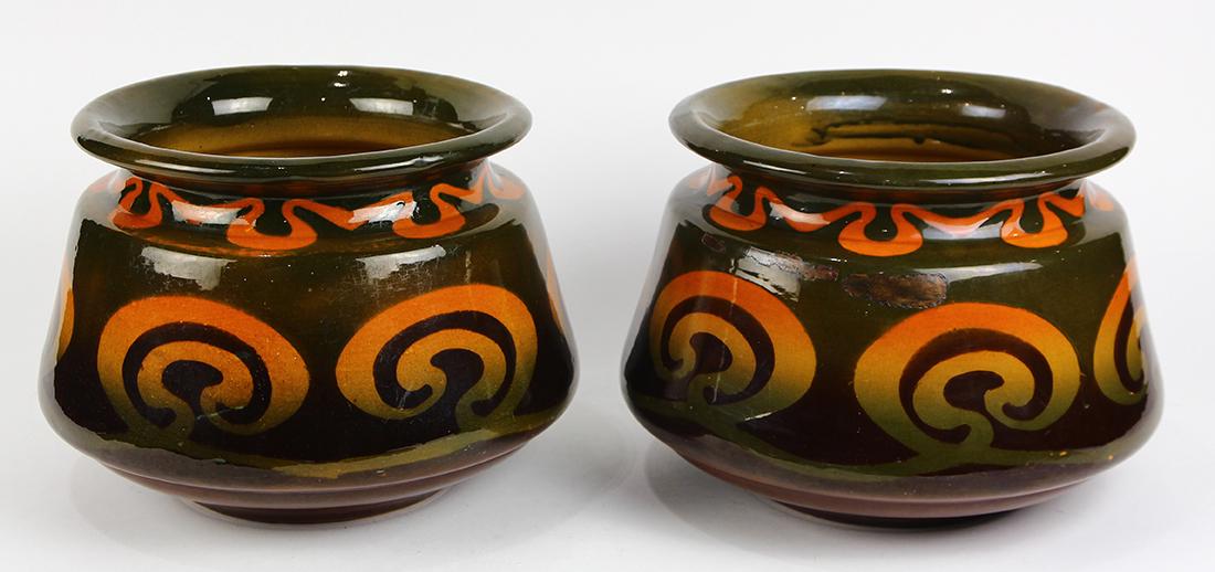 Pair of Art Nouveau Jardinieres, by JB Owens, each with: Pair of Art Nouveau Jardinieres, by JB Owens, each with a green, red and yellow scrolling pattern on a brown ground, 8"h x 12"dia.