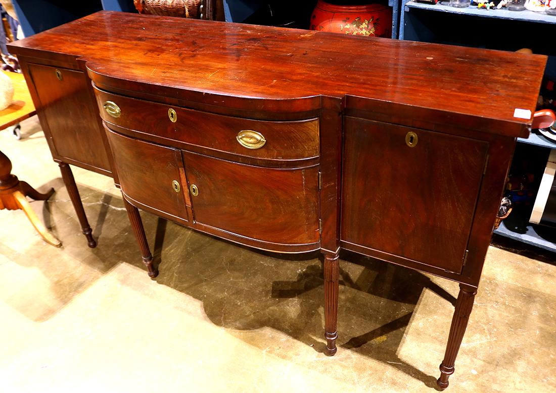 Sheraton mahogany sideboard, circa 1820, having a: Sheraton mahogany sideboard, circa 1820, having a rectangular top, above a single drawer case and rising on tapered and reeded legs, 40"h x 70.5"w x 24"d