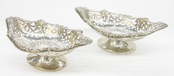 English sterling silver baskets: Pair of English sterling silver diminutive baskets made by John Marshall of London 1899, elliptic repousse rose border with reticulated bowl on oval foot, 2''h x 7''w, 6 ozs.