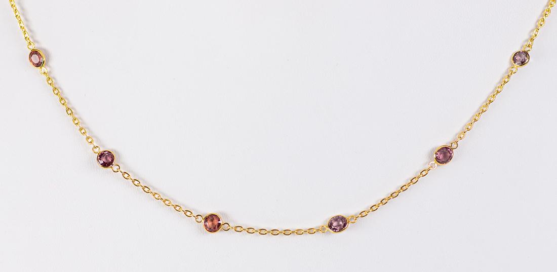 Spinel and 18k yellow gold necklace: Spinel and 18k yellow gold necklace Featuring (39) round-cut spinels, weighing a total of approximately 8.00 cts., set in and inter linked by a 1.15 mm, 18k yellow gold open link chain, completed by a