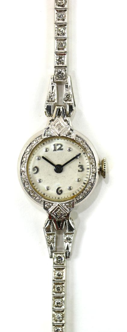 Lady's Bulova diamond and 14k white gold wristwatch: Lady's Bulova diamond and 14k white gold wristwatch Dial: round, white, applied white Arabic numeral and dot hour markers, outer black minutes track, black baton hands Movement: stem set and wind, 17