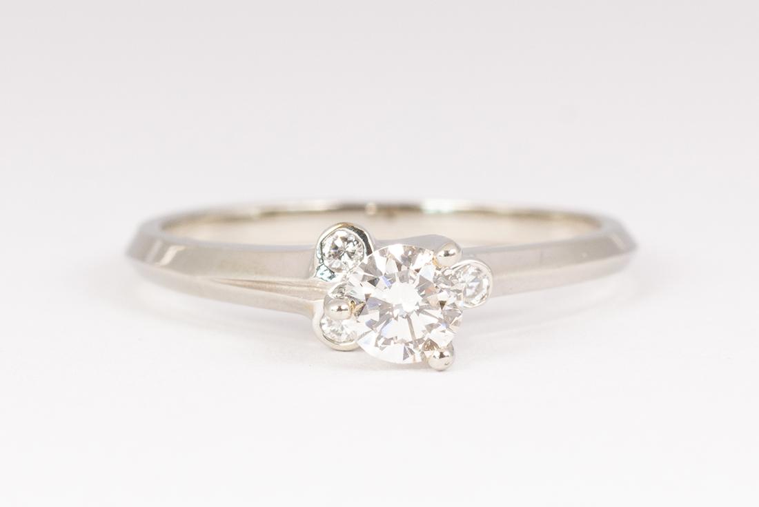 Diamond and 18k white gold ring: Diamond and 18k white gold ring Centering (1) round brilliant-cut diamond, weighing approximately 0.20 ct., accented by (3) full-cut diamonds, weighing approximately 0.05 ct., set in an 18k white gold