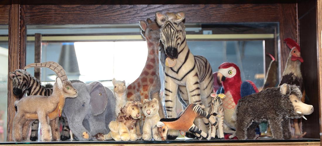 One shelf of mostly Steiff animals, including a zebra,: One shelf of mostly Steiff animals, including a zebra, a giraffe, an elephant, etc. Largest 14"h