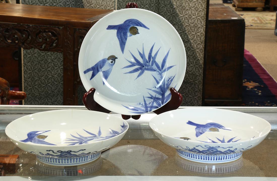 Japanese Nabeshima Porcelain Plates, Edo period: (lot of 3) Japanese Nabeshima blue-and-white porcelain plates, Edo period, depicting a pair of sparrows flying over the bamboo branch, 8"dia
