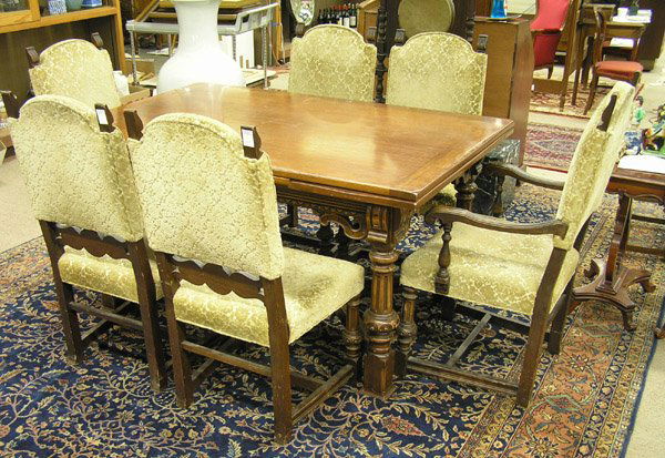 Walnut dining room set 1920s: Jacobbean style Walnut dining room set, late 1920's, consisting of a draw leaf table, 31''h x 62''w x 40''d, a set of 6 matching chairs with fluted stretcher bases and a sideboard, 69''w