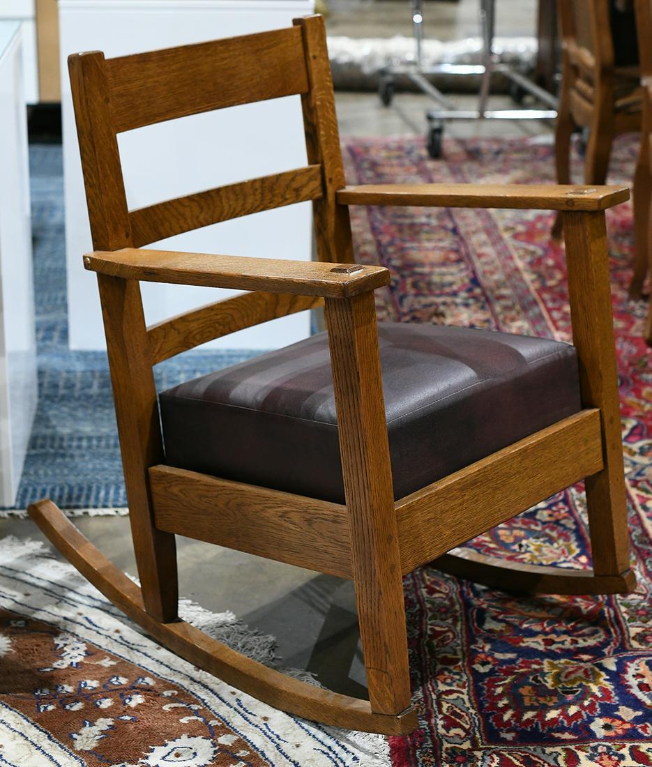 Arts and Crafts quarter sawn oak rocking chair, having: Arts and Crafts quarter sawn oak rocking chair, having a splat back above the brown leather seat, 33"h x 25"w