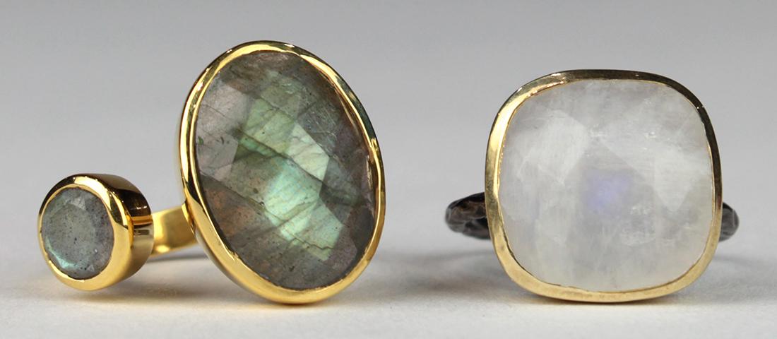 (Lot of 2) Moonstone, labradorite, blackened and: (Lot of 2) Moonstone, labradorite, blackened and gilted-silver rings Including 1) ring, featuring (2) faceted top labradorites set in a silver-gilt asymmetric/open mounting, size 7.75; together with 1