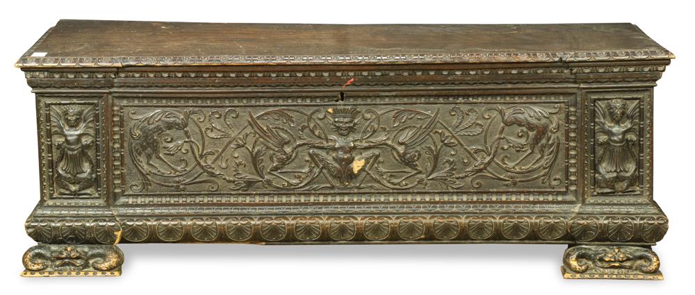 Massive Baroque style ebonized oak blanket chest: Massive Baroque style ebonized oak blanket chest, the outset rectanguar top carved with an egg and dart border, a linen fold cornice, the front centering a carved figure of a crowned beast, within a f