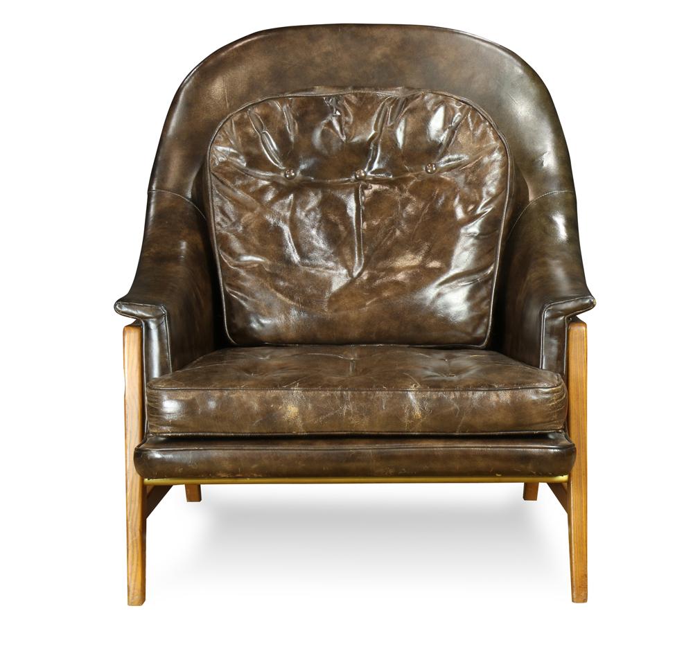 Edward Wormley for Dunbar teak and leather tufted,: Edward Wormley for Dunbar teak and leather tufted, upholstered lounge chair, the rounded upholstered back over twin padded arms raised on blond stained teak square stretcher joined legs with a center 