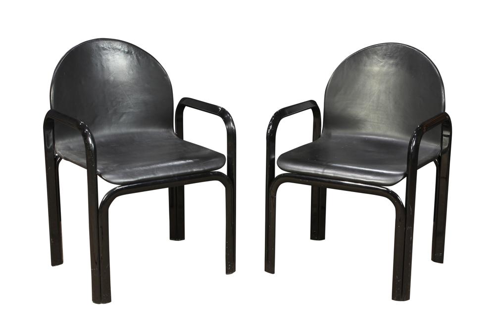 (lot of 2) Gae Aulenti for Knoll black leather: (lot of 2) Gae Aulenti for Knoll black leather armchairs, each having a shaped back above an ebonized metal frame, 32"h