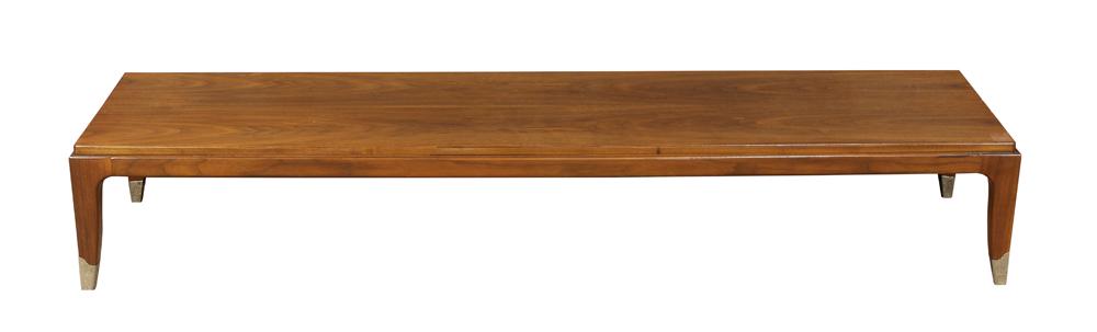 Mid-Century Modern Robsjohn-Gibbings style low table: Mid-Century Modern Robsjohn-Gibbings style low table, having a rectangular top, above tapered legs terminating on brass caps, 11"h x 64"w x 17"d