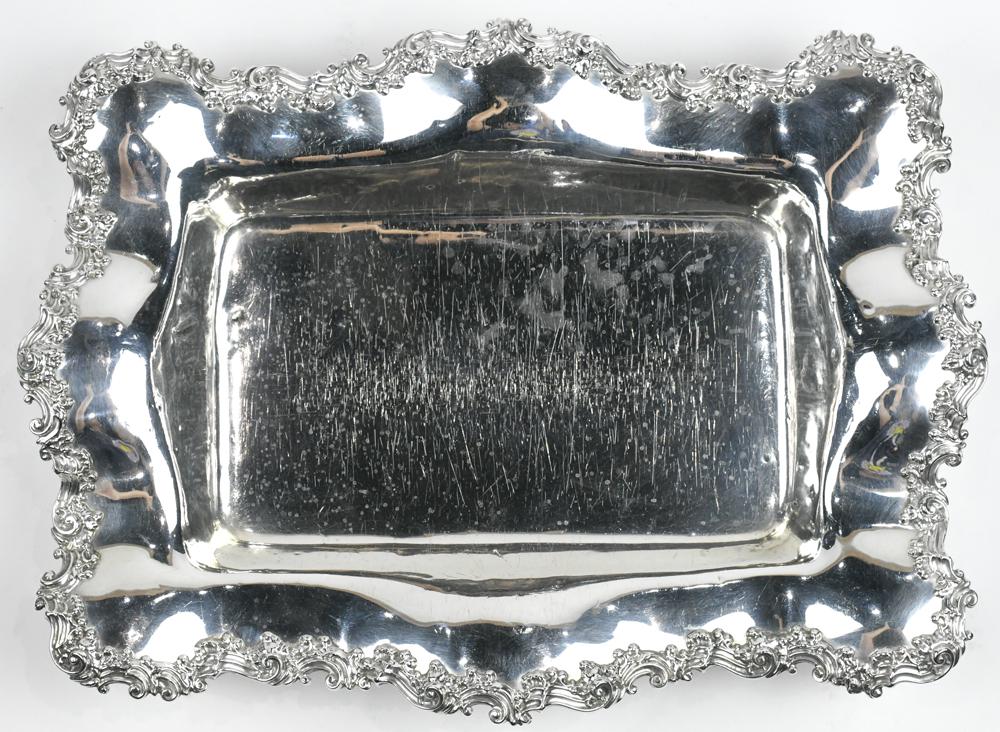 Mauser Manufacturing Company sterling silver serving: Mauser Manufacturing Company sterling silver serving dish, having a relief molded rocaille and scallop rim, framing the rectangular bowl and rising on four outswept feet embellished with rosette motif