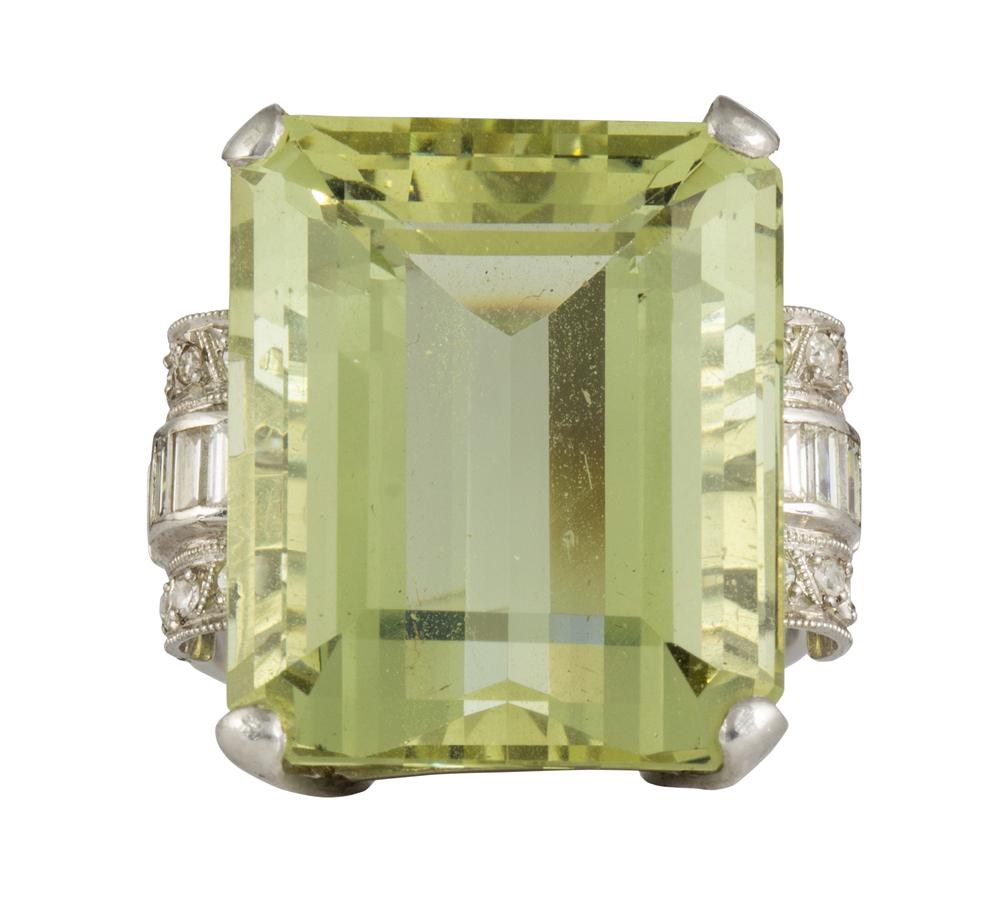 Beryl, diamond and platinum ring: Beryl, diamond and platinum ring Featuring (1) emerald-cut green beryl, weighing approximately 20.75 cts., flanked by (6) baguette and (11) single-cut diamonds, (1 diamond is missing), weighing a tota