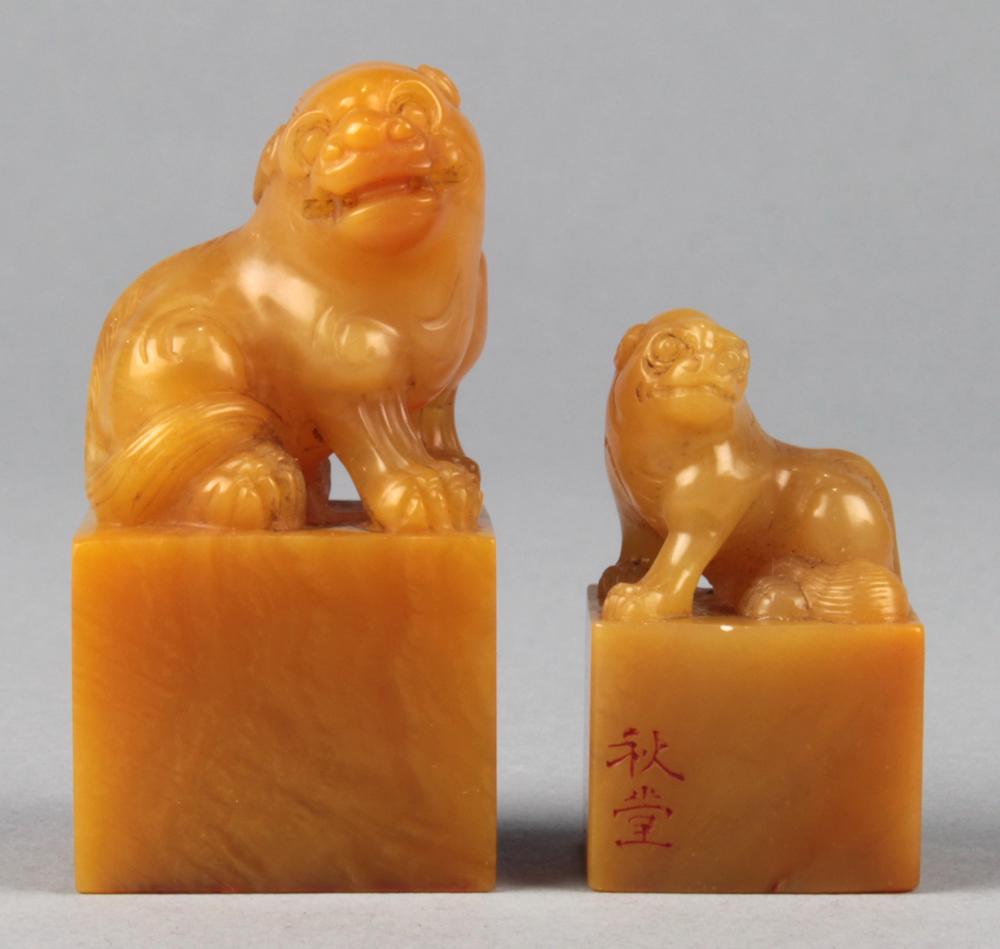 Chinese Yellow Soapstone Seals: (lot of 2) Chinese soapstone seals, each of a mythical beast seated on its haunches, side incised and base carved, largest: 2"h