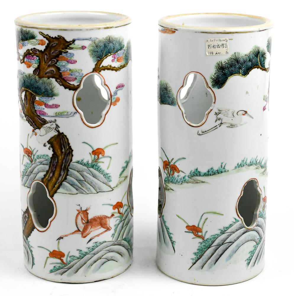 Chinese Porcelain Hat Stands, Cranes/Deer: Pair of enameled porcelain hat stands, of cylindrical form with lobed apertures, exterior featuring deer and cranes amid gnarled pines, base with Tongzhi mark,10.75"h