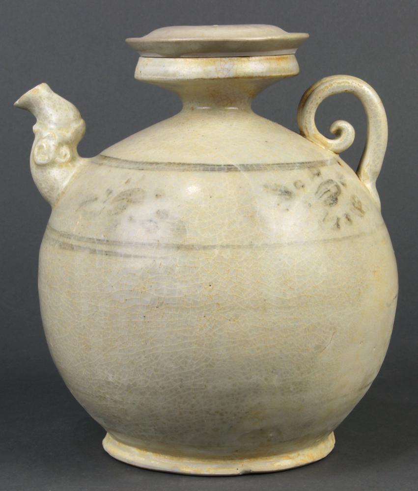 Vietnamese White Glazed Ewer: Vietnamese white glazed lidded ewer with iron wash, Tran dynasty (13th c), everted dish rim above the globular body featuring a stylized floral band, having a short shaped spout and scroll handle; tog