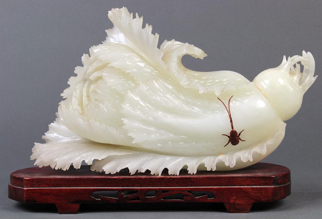 Chinese Carving of a Cabbage: Chinese stone carving, in the form of a cabbage/bokchoy accented by a brown beetle, with wood stand, cabbage: 10.25"w
