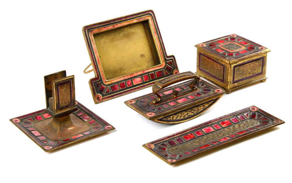(lot of 5) Tiffany Studios New york "Art Deco" pattern: (lot of 5) Tiffany Studios New york "Art Deco" pattern bronze desk set, each having a red enamel geometric decorated body, consisting of a calendar holder frame 356, covered inkwell 357, ink blotter 3
