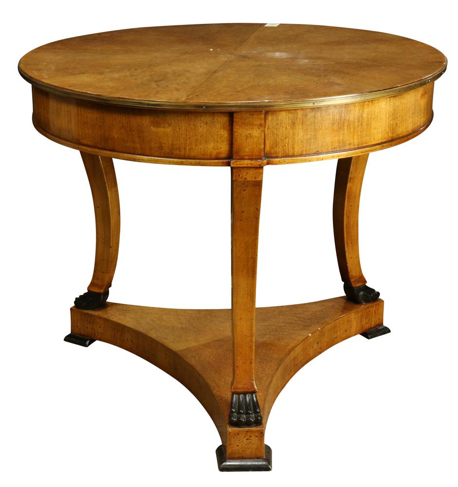 Biedermeier style birdseye maple center table: Biedermeier style birdseye maple center table, the highly figured circular top with applied patinated metal banding, above the inswept legs having ebonized paw form feet resting on the trapezoidal bas