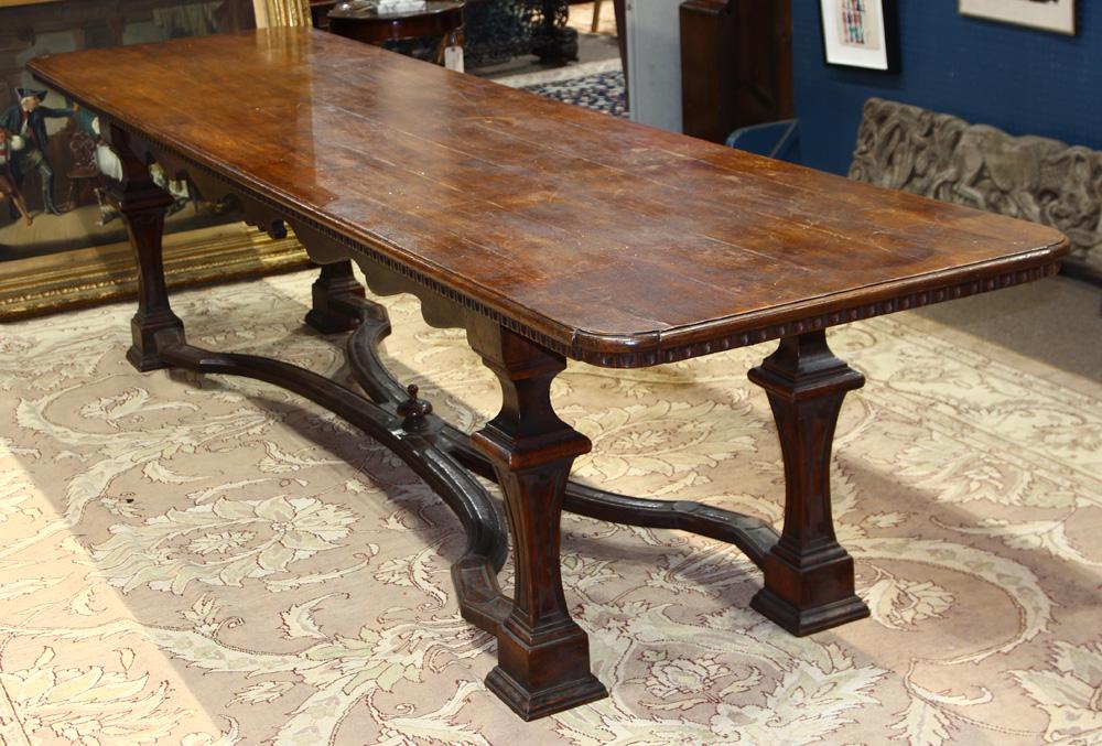 Continental Baroque style dining table: Continental Baroque style dining table, having a rectangular top, above tapered legs conjoined by an X-form stretcher, 32"h x 134"w x 33"d