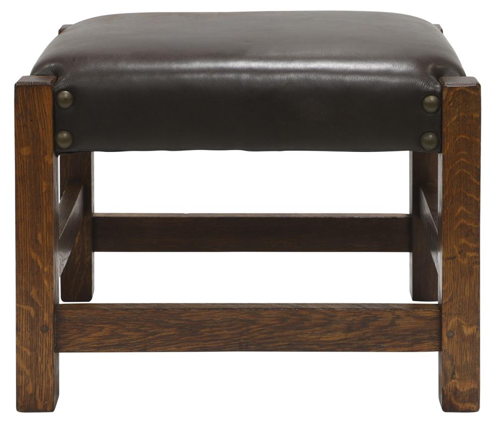 Gustav Stickley Arts and Crafts footstool model 300: Gustav Stickley Arts and Crafts footstool model 300, executed in oak, having fresh leather upholstery with brass nail head trim, and rising on square legs, 15.5"h x 20"w x 16"d