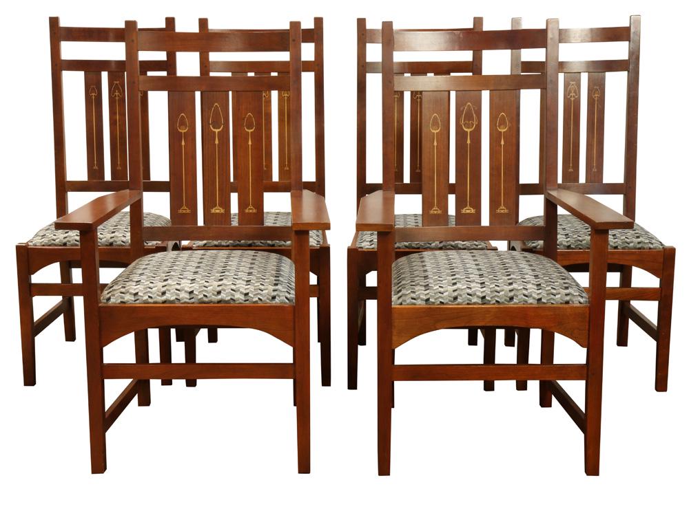 Stickley Audi Harvey Ellis Arts and Crafts style inlaid: Stickley Audi Harvey Ellis Arts and Crafts style inlaid dining chairs, each having a high contoured back with stylized metal inlay, drop in seat, and rising on square legs, consisting of (2) armchairs