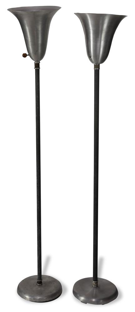 Pair of Mid Century floor lamps in the manner of Robert: Pair of Russel Wright aluminum floor lamps, having a tapered shade and rising on a circular base, 64"h