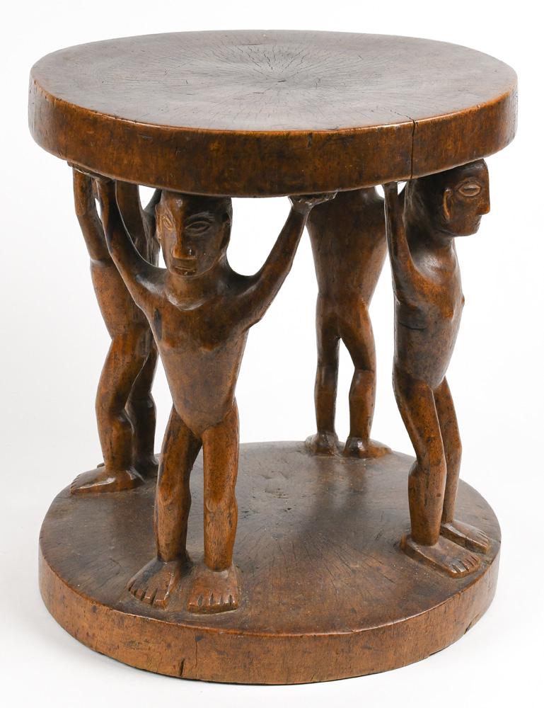 A finely garved Ifugao Northern Luzon stool: A finely garved Ifugao Northern Luzon stool, Philippines, the round seat rising on four carved figural supports, with some apparent age and handling, 12.5"h x 10.25"dia.