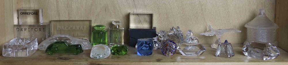 One shelf of paperweights: One shelf of paperweights, including (2) Orrefors and (1) Baccarat retail weight; a Tiffany & Co. scarab; four facet cut weights; five modern weights, one with label by Robert Held; a paperweight inkw