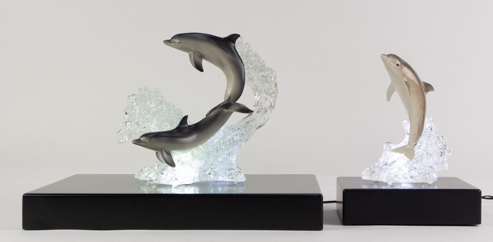(lot of 2) Robert Wyland acrylic limited edition: (lot of 2) Robert Wyland (American, b. 1956) acrylic limited edition sculptures, each depicting dolphins in the ocean, and rising on an illuminated ebonized plinth, the smaller numbered 158/350, the l