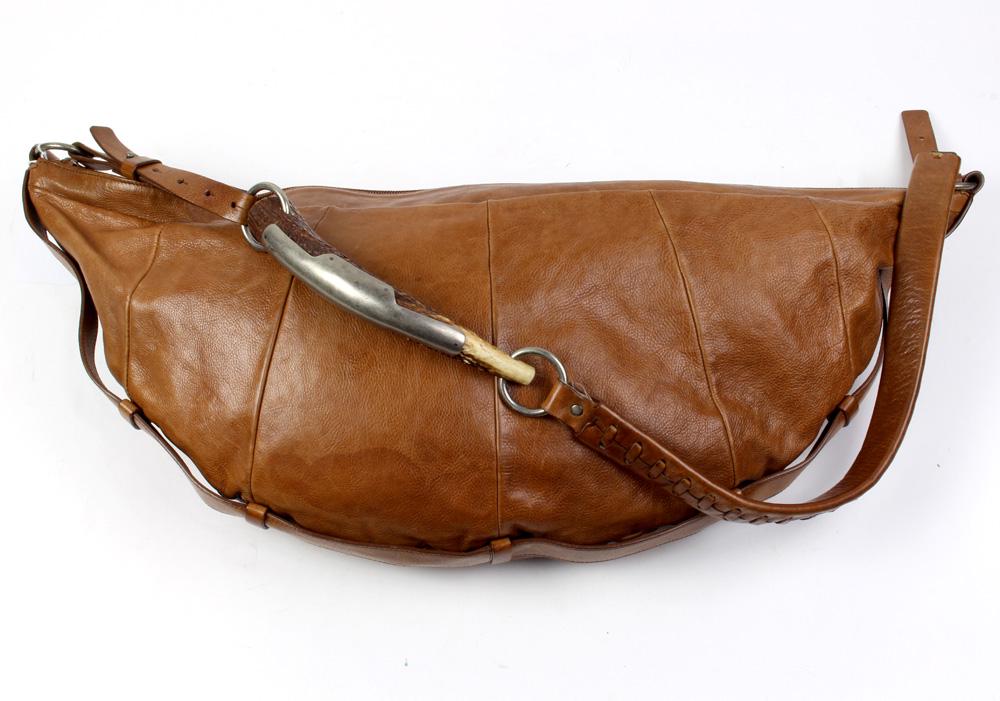 Yves St. Laurent Mombasa Sling Bag: Yves St. Laurent Mombasa Sling Bag, executed in tan grained calf leather, 63 x 28 x 3 cm