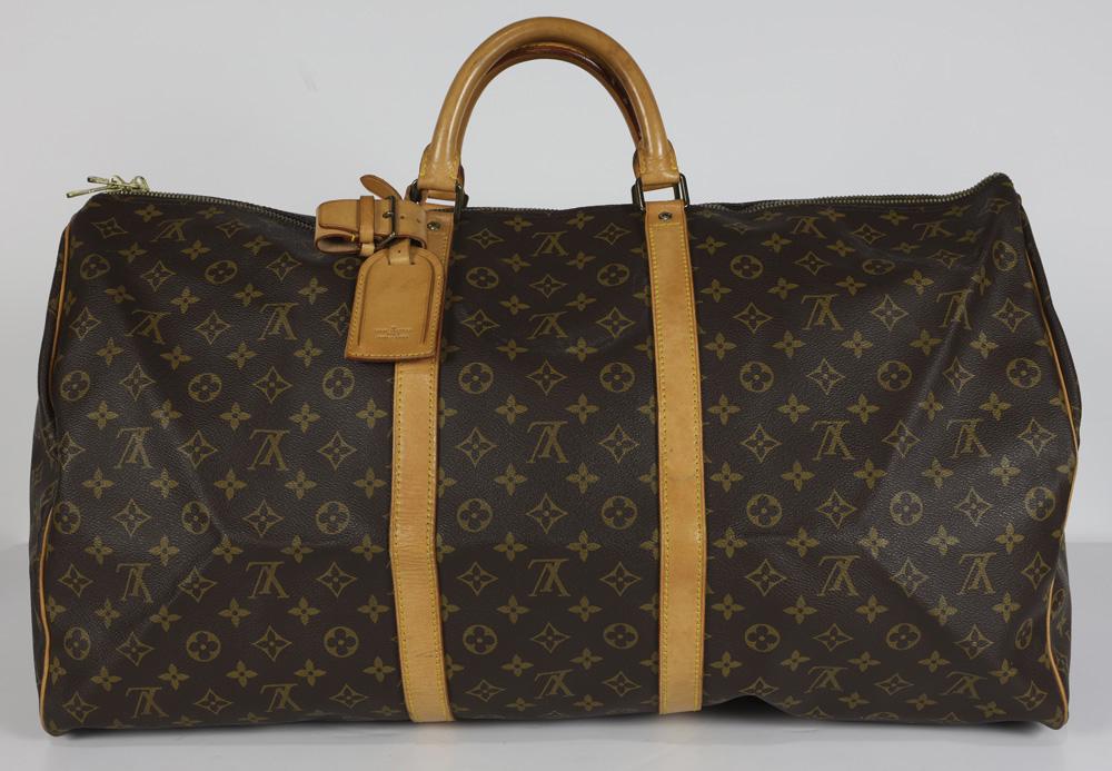 Louis Vuitton Keepall travel bag: Louis Vuitton Keepall travel bag, 60cm, executed in brown Monogram Coated Canvas, having luggage tag and handle strap, 60 x 26 x 31 cm