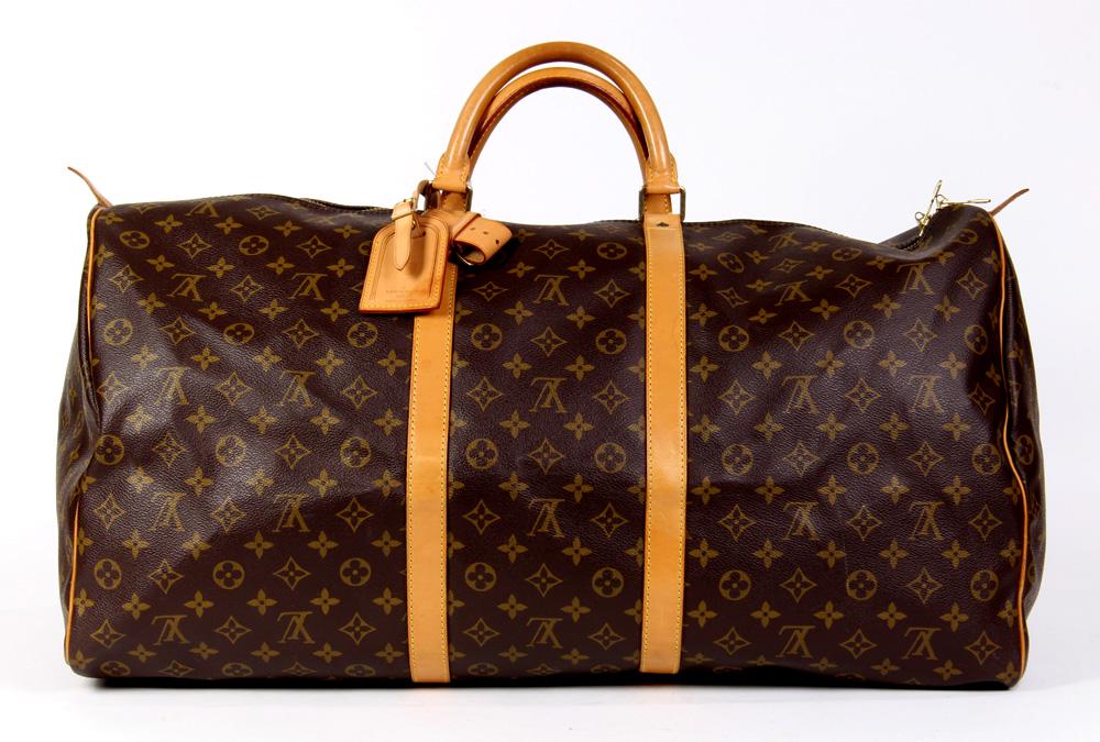 Louis Vuitton Keepall travel bag: Louis Vuitton Keepall travel bag, 60cm, executed in brown Monogram Coated Canvas, together with luggage tag and handle strap, 60 x 26 x 31 cm
