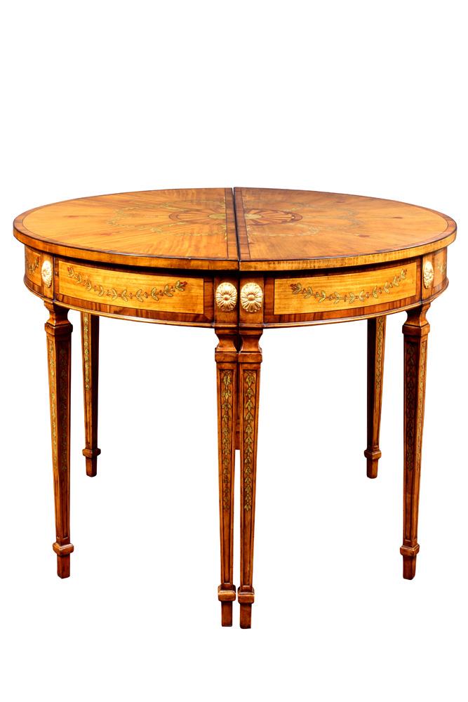 Pair of Regency style satinwood: Pair of Regency style satinwood, rosewood and paint decorated tables, each of demi lune form, the aprons with gilt rosette medallions, and rising on tapered legs having painted bell flower reserves te