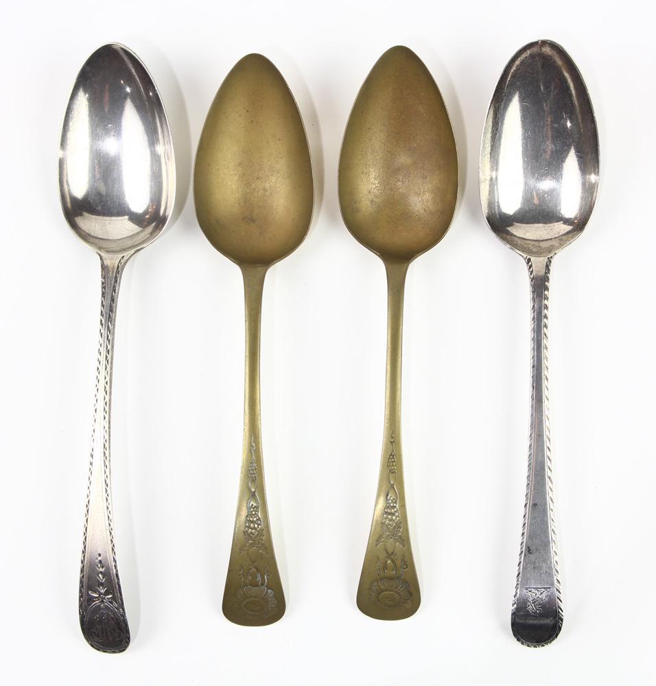 (lot of 4) (2) George III sterling tablespoons, bearing: (lot of 4) (2) George III sterling tablespoons, bearing Hester Bateman hallmarks, London, one dated 1784, each spoon with feather edge border and bright cut engraved decoration, one with a lion crest,