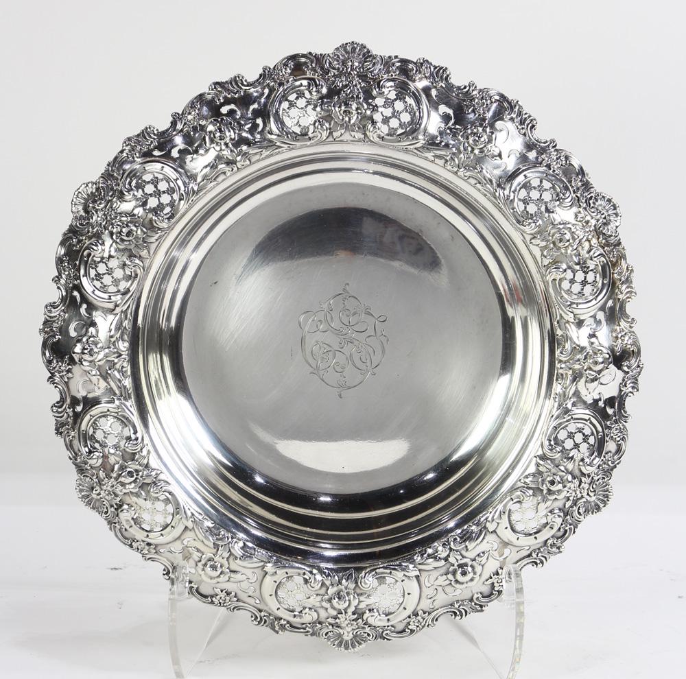 Tiffany & Co. sterling centerpiece in the Rococo: Tiffany & Co. sterling centerpiece in the Rococo Revival taste, circa 1898, the inverted hat form with a flaring rim with alternating reticulated diaper cartouches and repousse floral sprays, a rocail