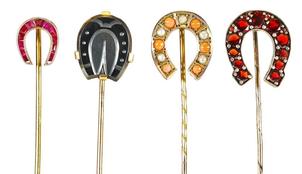 (Lot of 4) Multi-stone, yellow gold, metal horseshoe: (Lot of 4) Multi-stone, yellow gold, metal horseshoe stickpins Including 1) ruby, platinum-topped 18k yellow gold horseshoe stickpin (one stone has been replaced); 1) carved hematite, 10k yellow gold