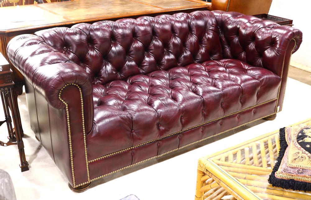 Chesterfield burgundy leather sofa: Chesterfield burgundy leather sofa, having a tufted seat and back, and accented with brass nail head trim, 29"h x 72"w x 22"d