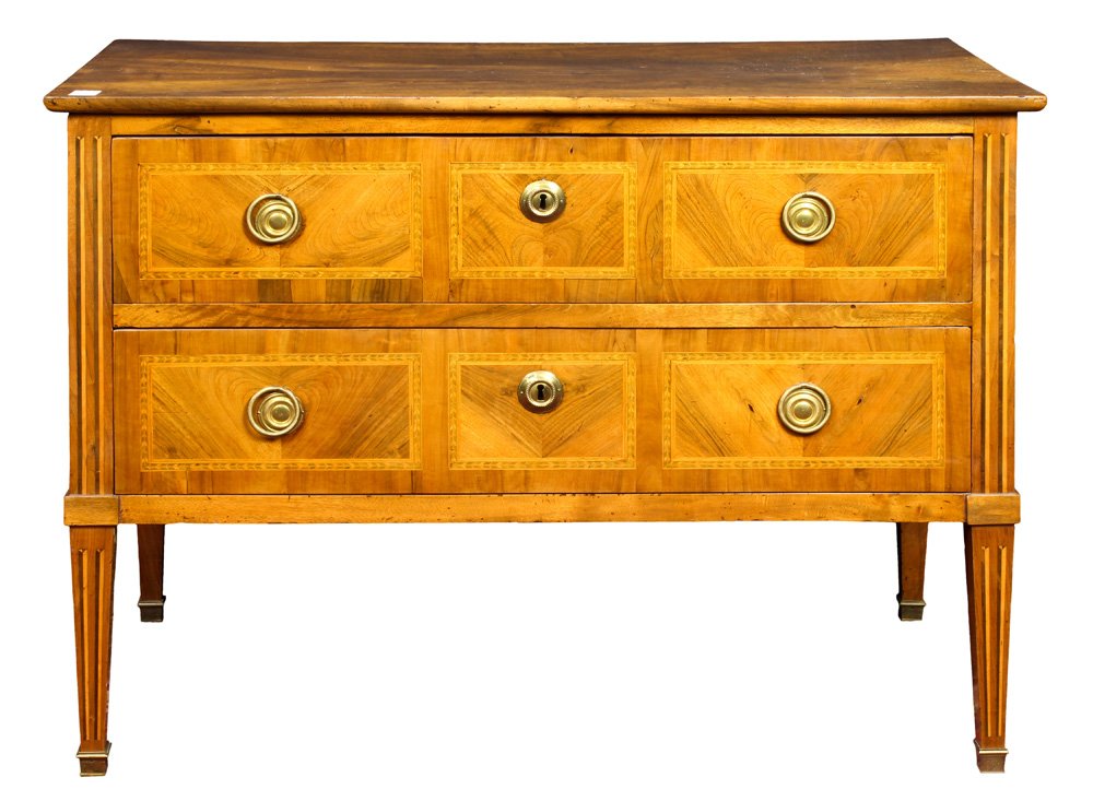 A French Louis XVI marquetry decorated commode circa: A French Louis XVI marquetry decorated commode circa 1770, having a two drawer case with marquetry banding, and rising on tapered legs terminating on sabots, 34.5"h x 23"w x 46.25"d