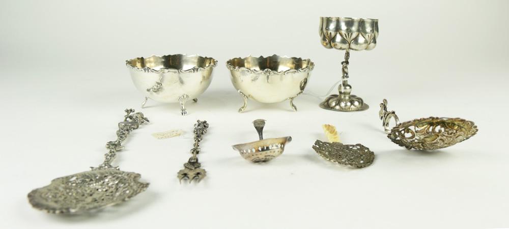 (lot of 8) 7 Continental Rococo .800 silver table: (lot of 8) 7 Continental Rococo .800 silver table articles: a figural chalice 4.75"h; (2) footed silver bowls; (3) reticulated spoons, longest 11"l; a Nuremberg St. Luke fork, several with Hanau marks