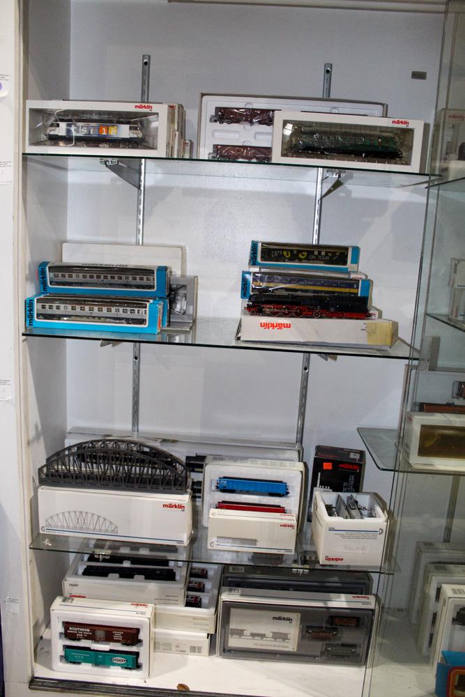 Four shelves of Marklin train cars, engines and track (1 of 2)